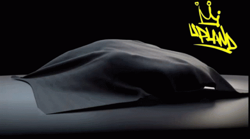 A Black Car With A Yellow Crown And The Word Upland On The Bottom GIF