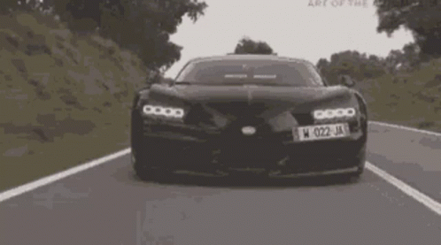 a black car with the license plate w 022 ja is driving down a road