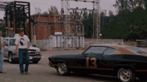 A Black Car With The Number 13 On It GIF