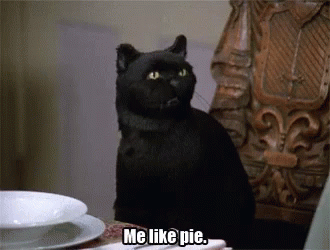 A Black Cat Sitting At A Table With The Words Me Like Pie Below It GIF