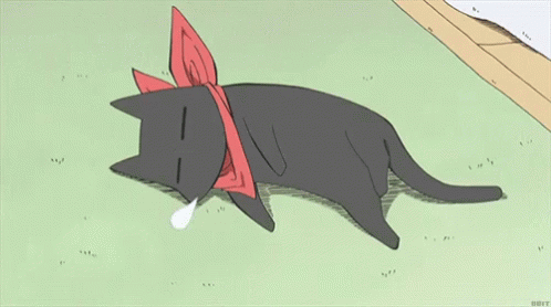 A Black Cat With A Red Bow Around Its Neck Is Laying Down On The Grass GIF