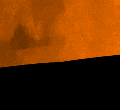 A Black Cat With Bright Yellow Eyes Is Peeking Out From Behind A Wall GIF