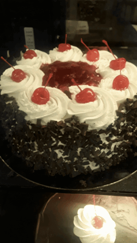 a black forest cake with whipped cream and cherries