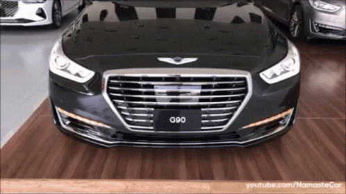 A Black G90 Car Is Parked On A Wooden Floor GIF