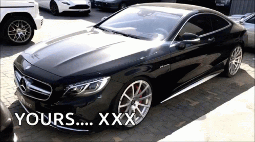 A Black Mercedes Is Parked In A Parking Lot With The Words Yours Xxx Written On The Bottom GIF