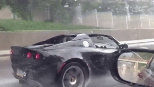 a black sports car with a license plate that says l.j.o. on it