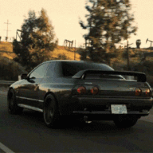 A Black Sports Car With A License Plate That Says ' Nzp ' On It GIF