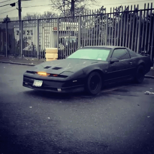 A Black Sports Car With A License Plate That Says Tnc 929 GIF