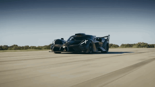 a black sports car with a white x on the side of it