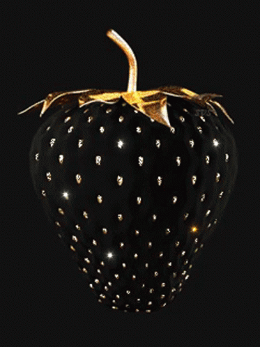 A Black Strawberry With Gold Spots And Leaves On A Black Background GIF