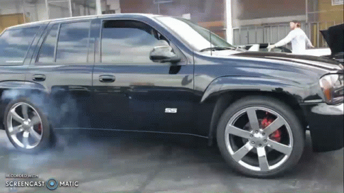 A Black Suv With The Letters Ss On The Side Of It GIF