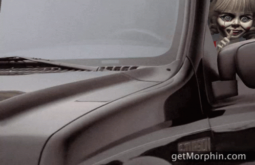 A Black Truck With A Doll Sticking Out Of The Window And The Website Getmorphin.com GIF