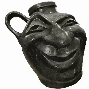 A Black Vase With A Smiling Face Carved Into It . GIF