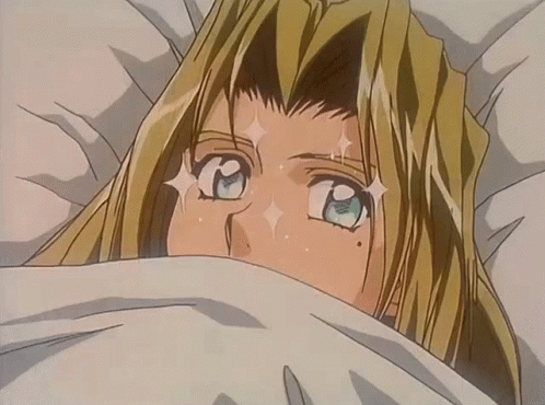 A Blonde Anime Character Is Laying In Bed With A White Blanket GIF