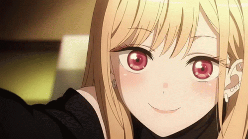 A Blonde Anime Girl With Red Eyes Is Smiling For The Camera GIF