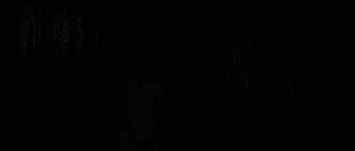 A Blonde Woman In A Pink Striped Shirt Looks At The Camera GIF
