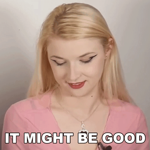 A Blonde Woman Is Wearing A Pink Shirt And Necklace And Says It Might Be Good . GIF