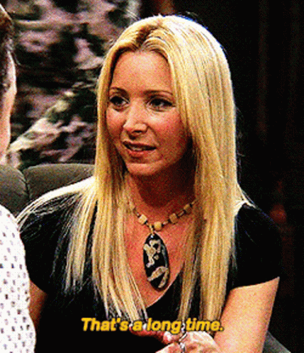 A Blonde Woman Says That 'S A Long Time In Yellow Letters GIF