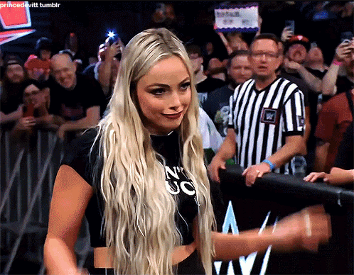 A Blonde Woman Wearing A Black Shirt That Says N ' Uc On It GIF
