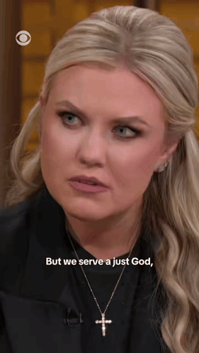 A Blonde Woman Wearing A Cross Necklace Says But We Serve A Just God GIF