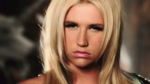 A Blonde Woman With A Nose Ring Is Making A Serious Face GIF