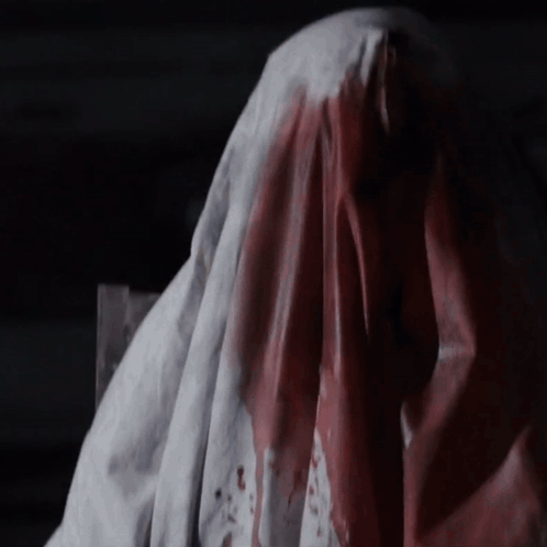 A Bloody Cloth Is Covering A Person 'S Head GIF