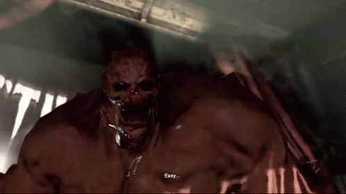 A Bloody Monster Is Standing In A Dark Room With His Arms Outstretched And His Mouth Open . GIF