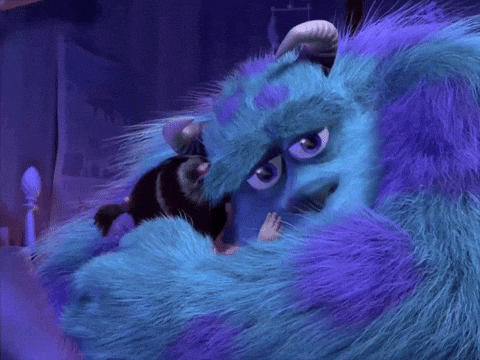 A Blue And Purple Furry Monster With Horns Is Hugging Another Monster GIF