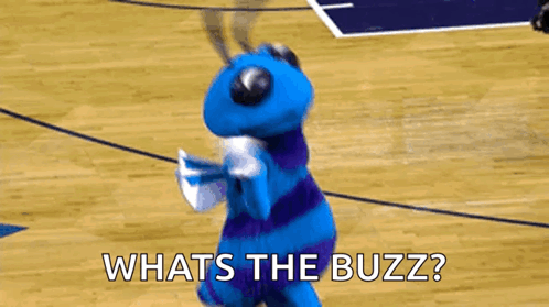 A Blue And Purple Mascot Is Dancing On A Basketball Court And Asking What 'S The Buzz ? GIF