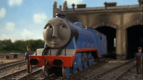 A Blue And Red Train With A Face That Says ' Thomas ' On It GIF