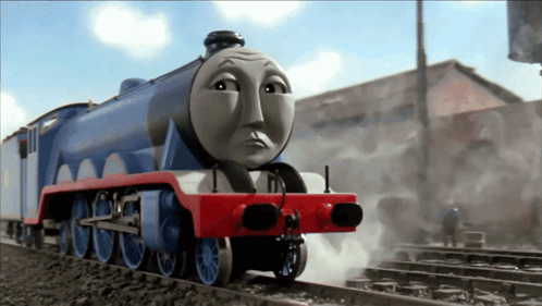 A Blue And Red Train With A Sad Face On It GIF