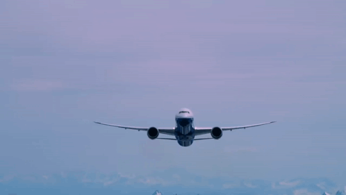 A Blue And White Airplane Flying In The Sky With The Number 777 On The Front GIF