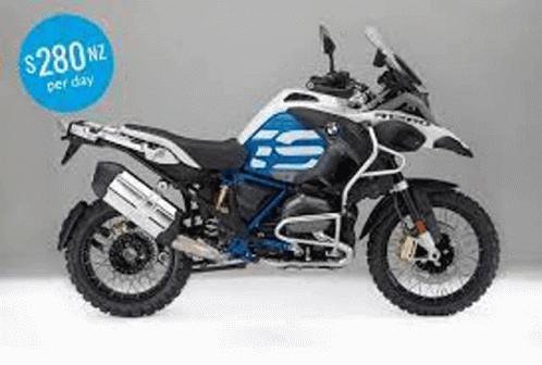 A Blue And White Bmw Gs Adventure Motorcycle Is Sitting On A White Surface . GIF