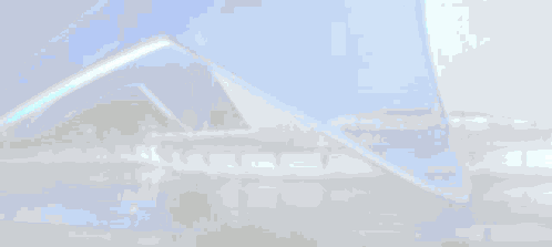 A Blue And White Building With A Reflection Of The Building In The Water . GIF