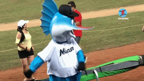 A Blue And White Fish Mascot Wearing A Miami Jersey GIF