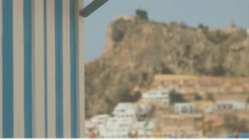 A Blue And White Striped Wall With A Red Crab In The Background GIF