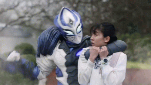 A Blue And White Superhero Is Holding A Woman In His Arms GIF