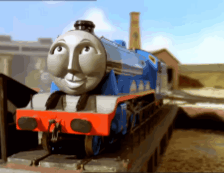 A Blue And White Train With A Face On The Front Of It GIF