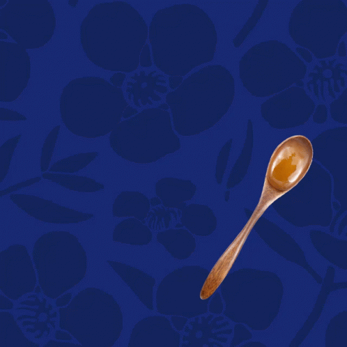 A Blue Background With A Wooden Spoon And The Words " One Spoon A Day " GIF