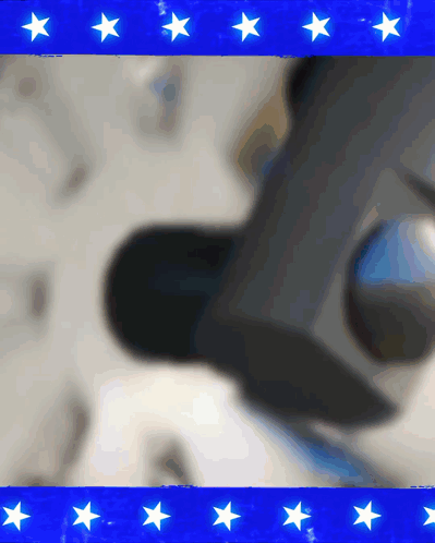 A Blue Background With White Stars And A Blurred Image Of A Person GIF
