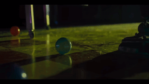 A Blue Ball Is Being Thrown Into A Green Liquid GIF