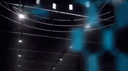 A Blue Bird Is Flying In The Air In Front Of A Blue Hexagon Wall . GIF