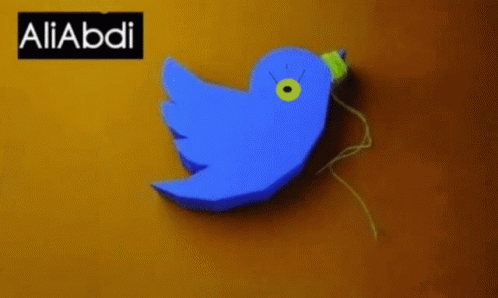 A Blue Bird With A Yellow Beak Is On A Yellow Background With The Name Aliabdi GIF