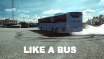 A Blue Bus Is Driving Down A Street With The Words Like A Bus Written Below It GIF
