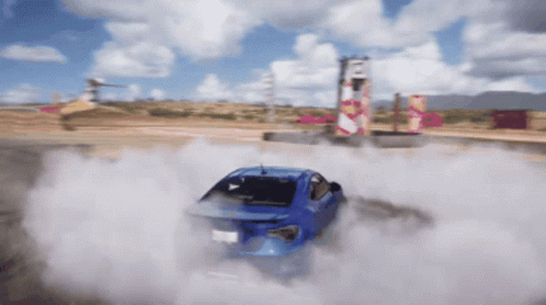 A Blue Car Is Drifting On A Dirt Track GIF