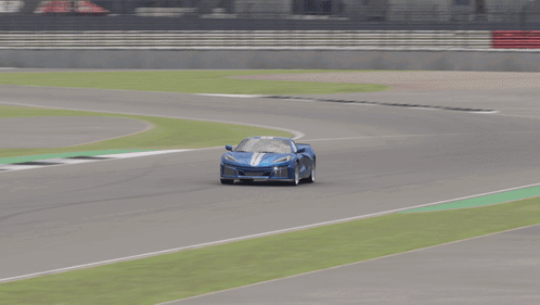 A Blue Car Is Driving Down A Race Track With A Sign That Says E On It GIF