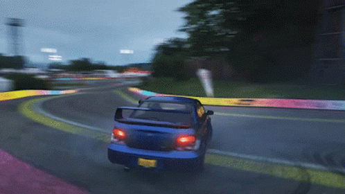 A Blue Car Is Driving Down A Road With A Yellow License Plate That Says ' Jc ' On It GIF