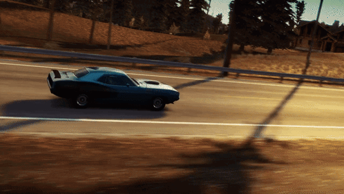 A Blue Car Is Driving Down A Road With Trees In The Background GIF