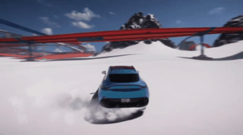 A Blue Car Is Driving Down A Snowy Road With Mountains In The Background GIF