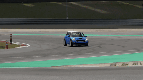 A Blue Car Is Driving On A Race Track GIF